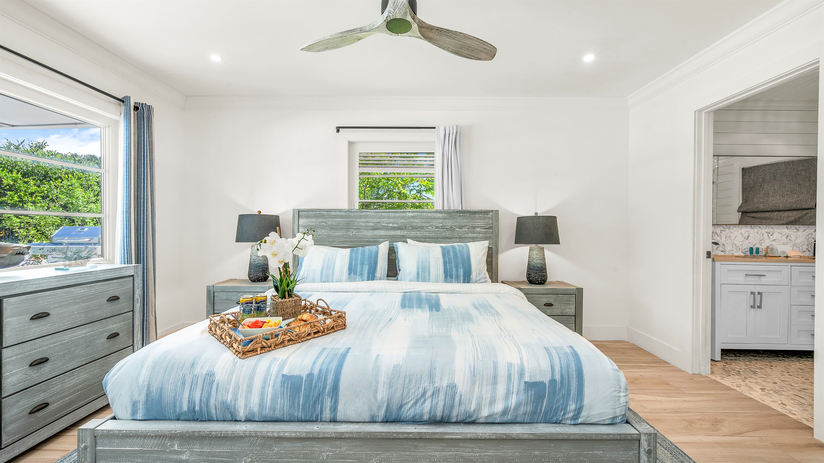 Primary Suite: King-size Tempur-Pedic Pro Adapt mattress, en-suite bath with dual-sink vanity. Pool views. 