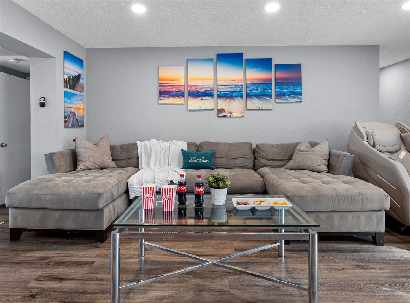 This spacious living room features a plush sectional, sleek decor, and contemporary artwork that blends perfectly with the modern aesthetic.