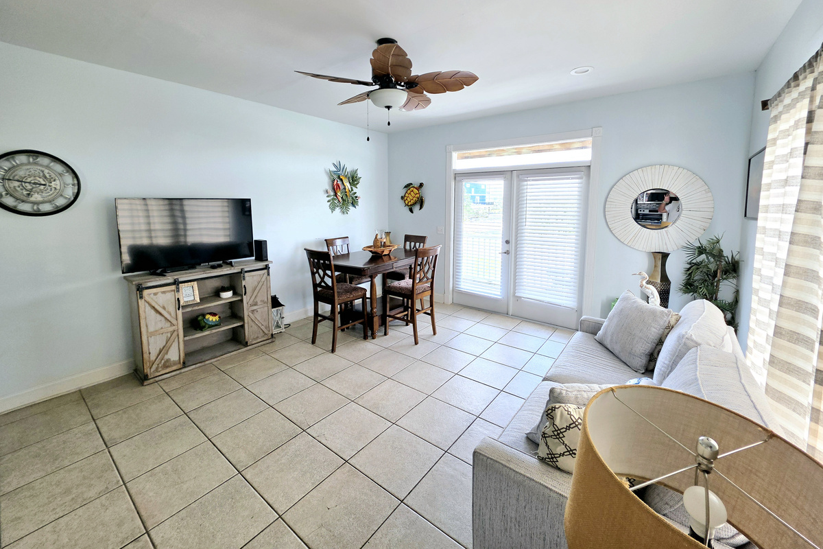 Living area with sofa, TV and dining table