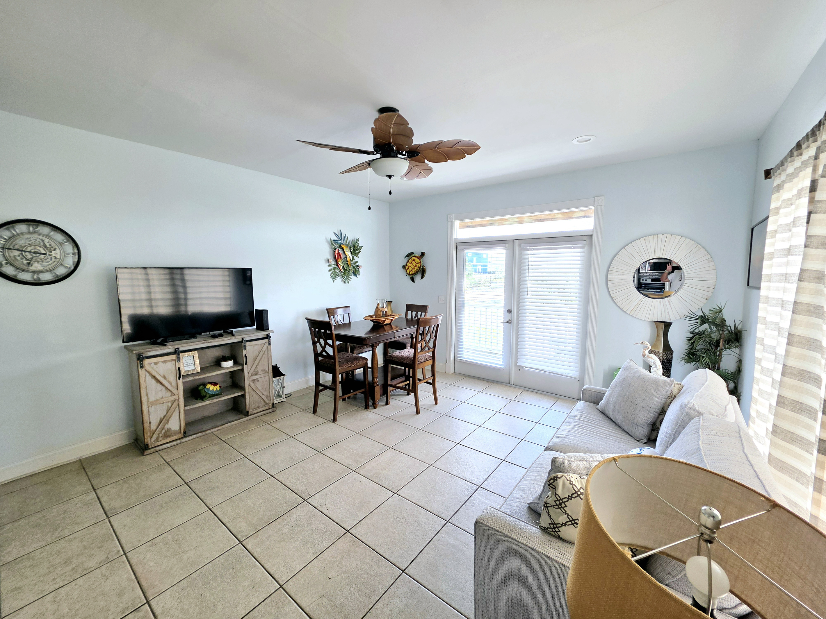 Living area with sofa, TV and dining table