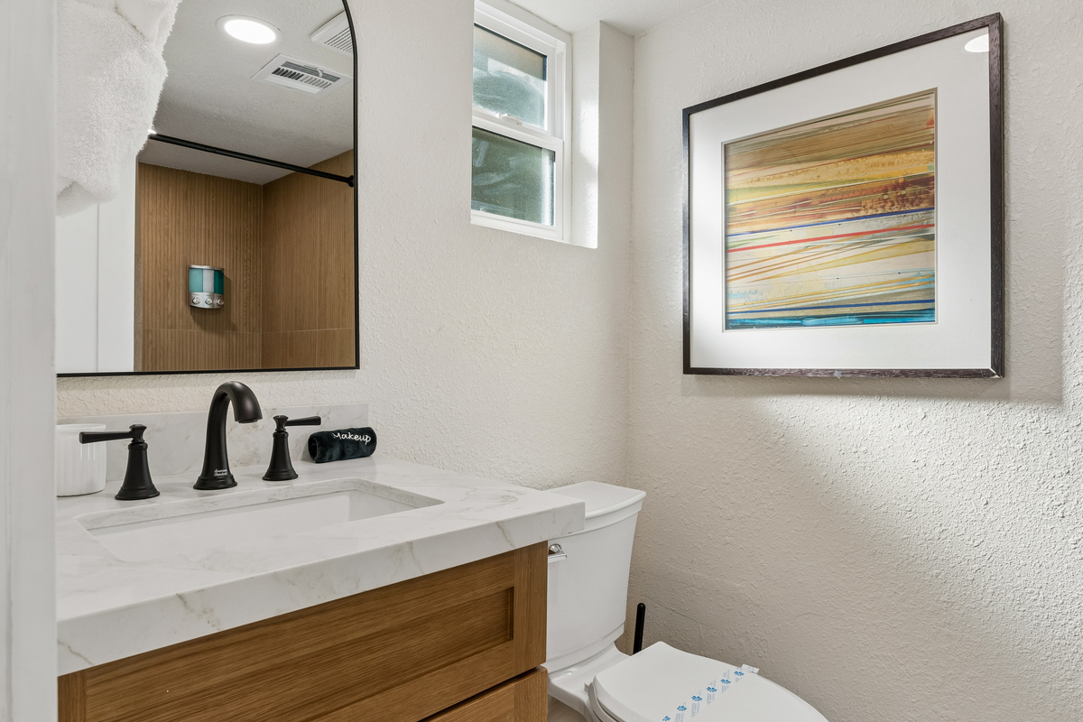 Freshen up in style and privacy in this on suite primary bathroom with an elegant shower.