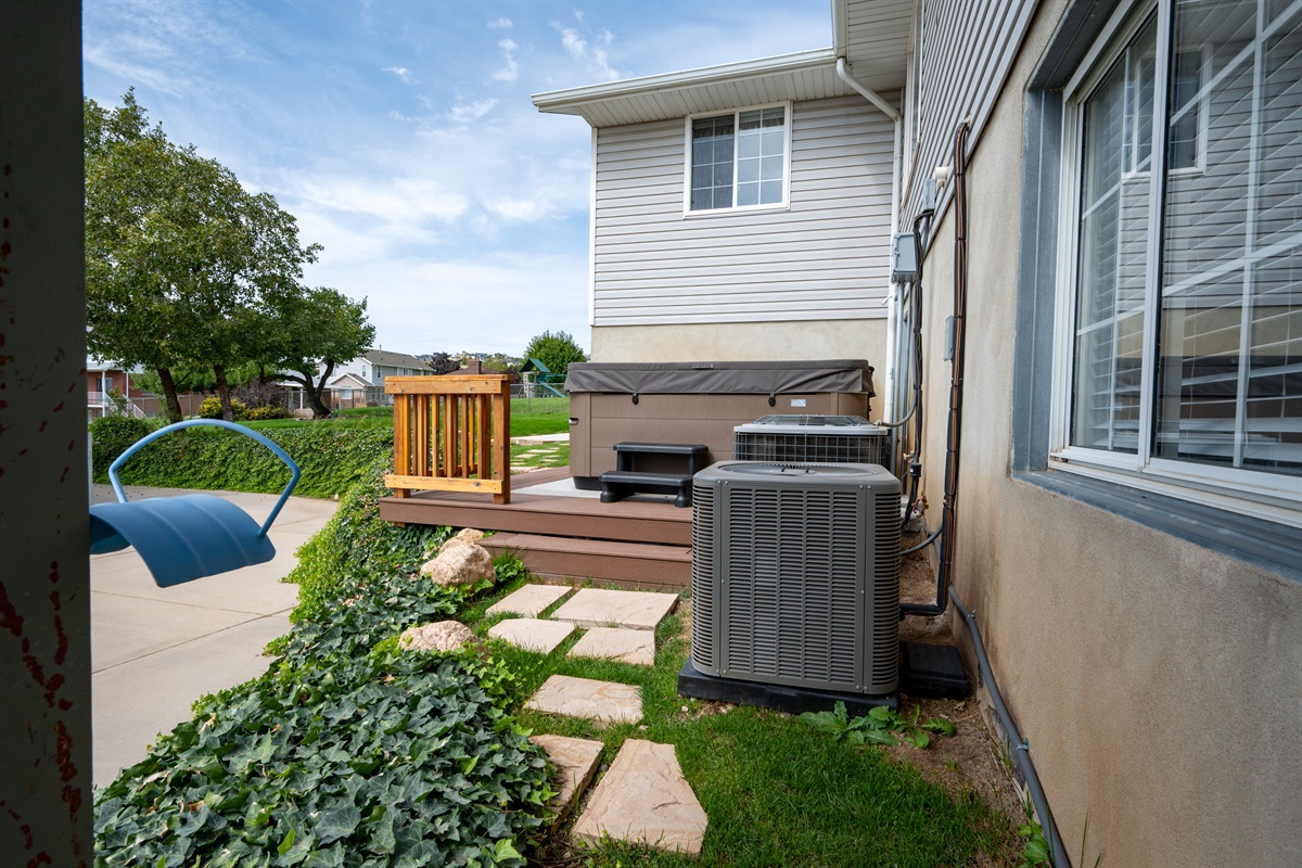 Spacious patio area with a private hot tub.