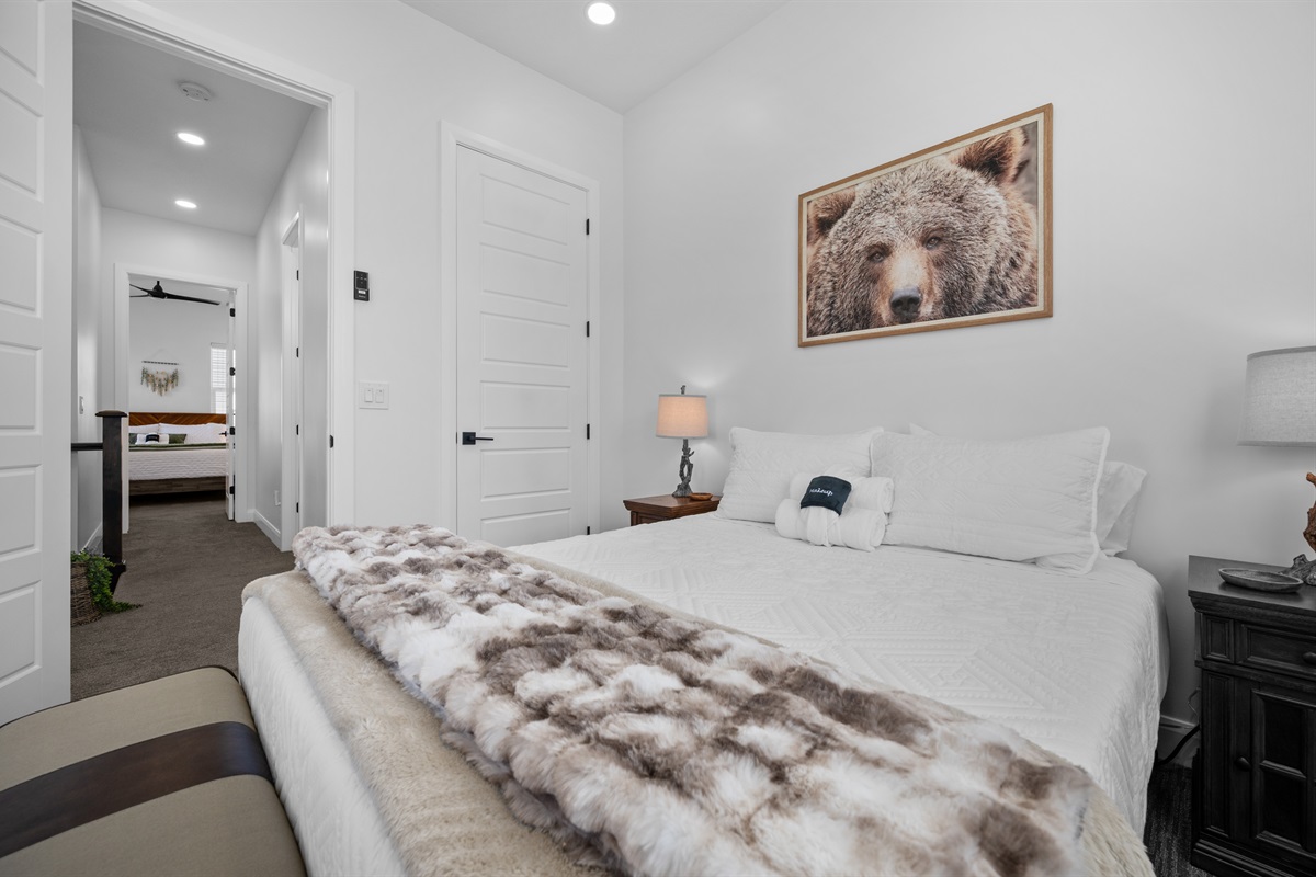 Comfortable queen bedroom with warm textures and a relaxing ambiance.