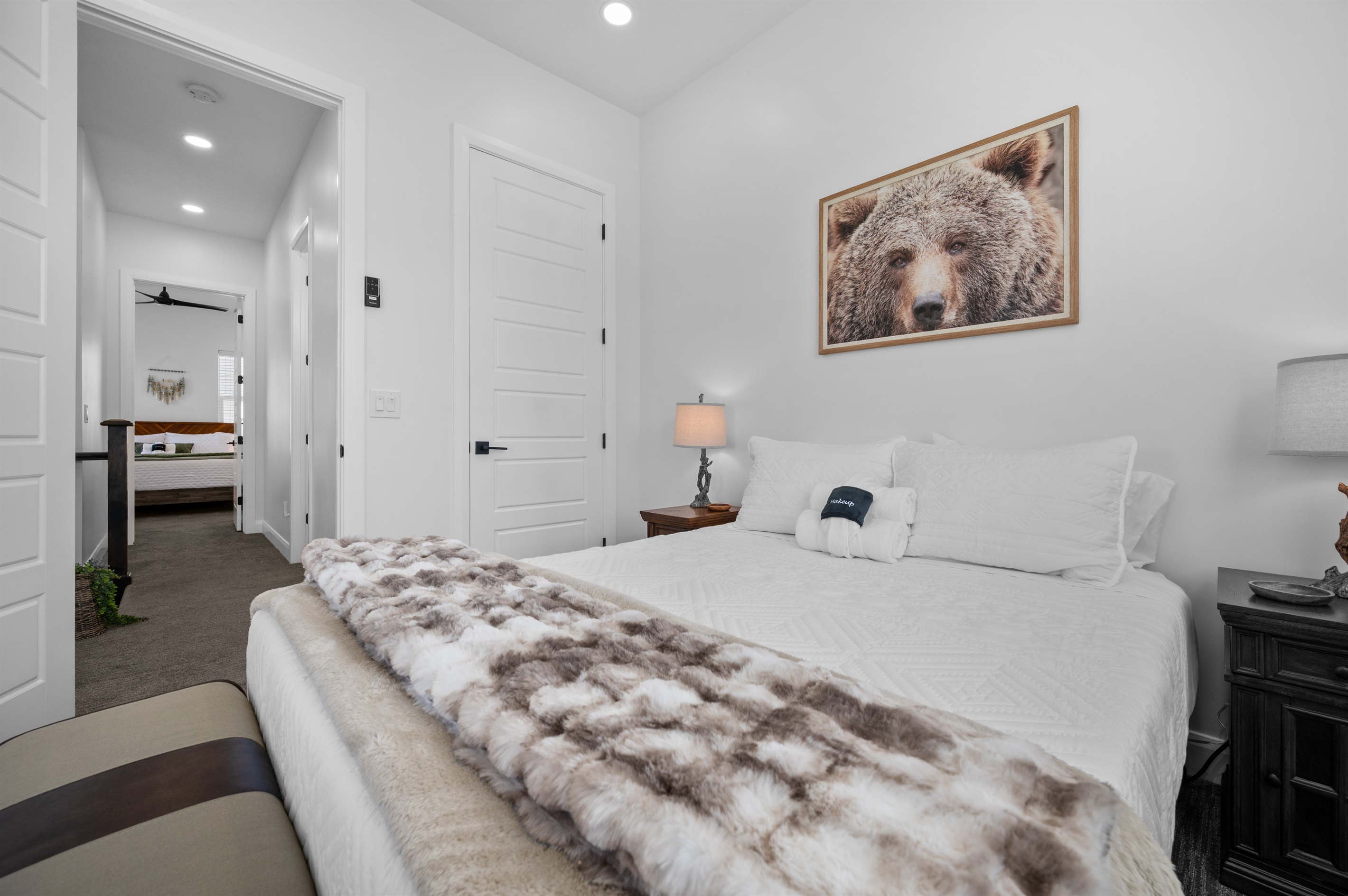 Comfortable queen bedroom with warm textures and a relaxing ambiance.