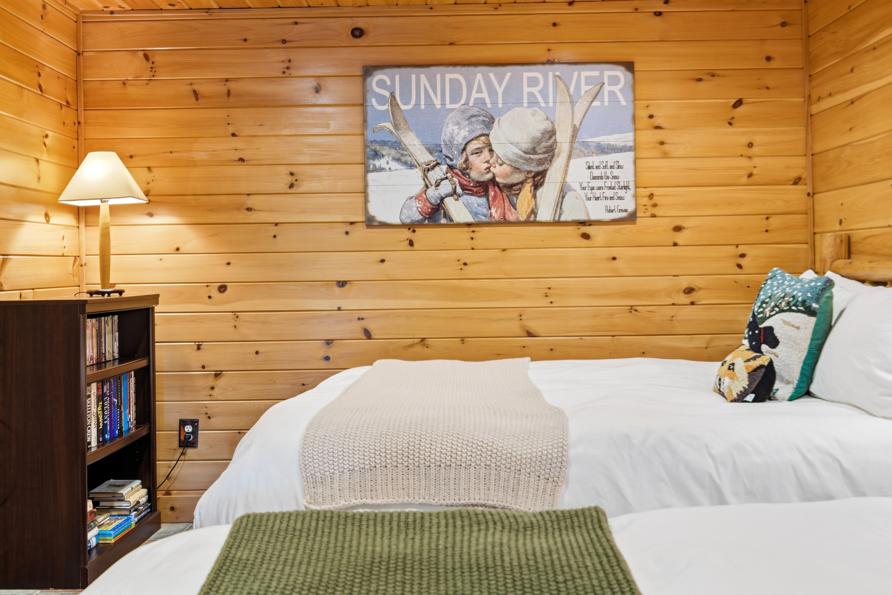 Comfortable sleeping space with warm wood interiors and cozy mountain-cabin charm.
