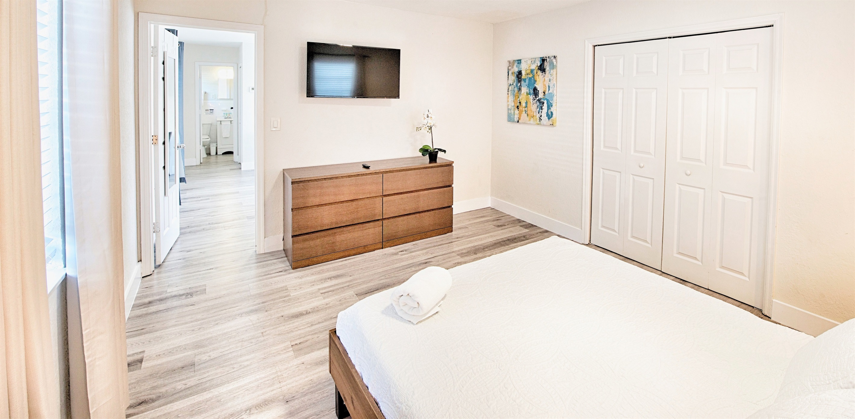 Primary bedroom with 40" smart TV and dresser