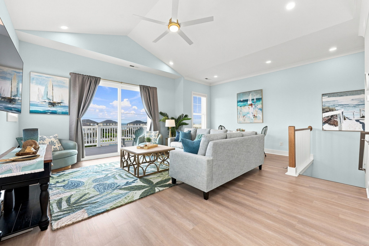 Enjoy open-concept coastal living with a bright space designed for conversations, movie nights, and making vacation memories together
