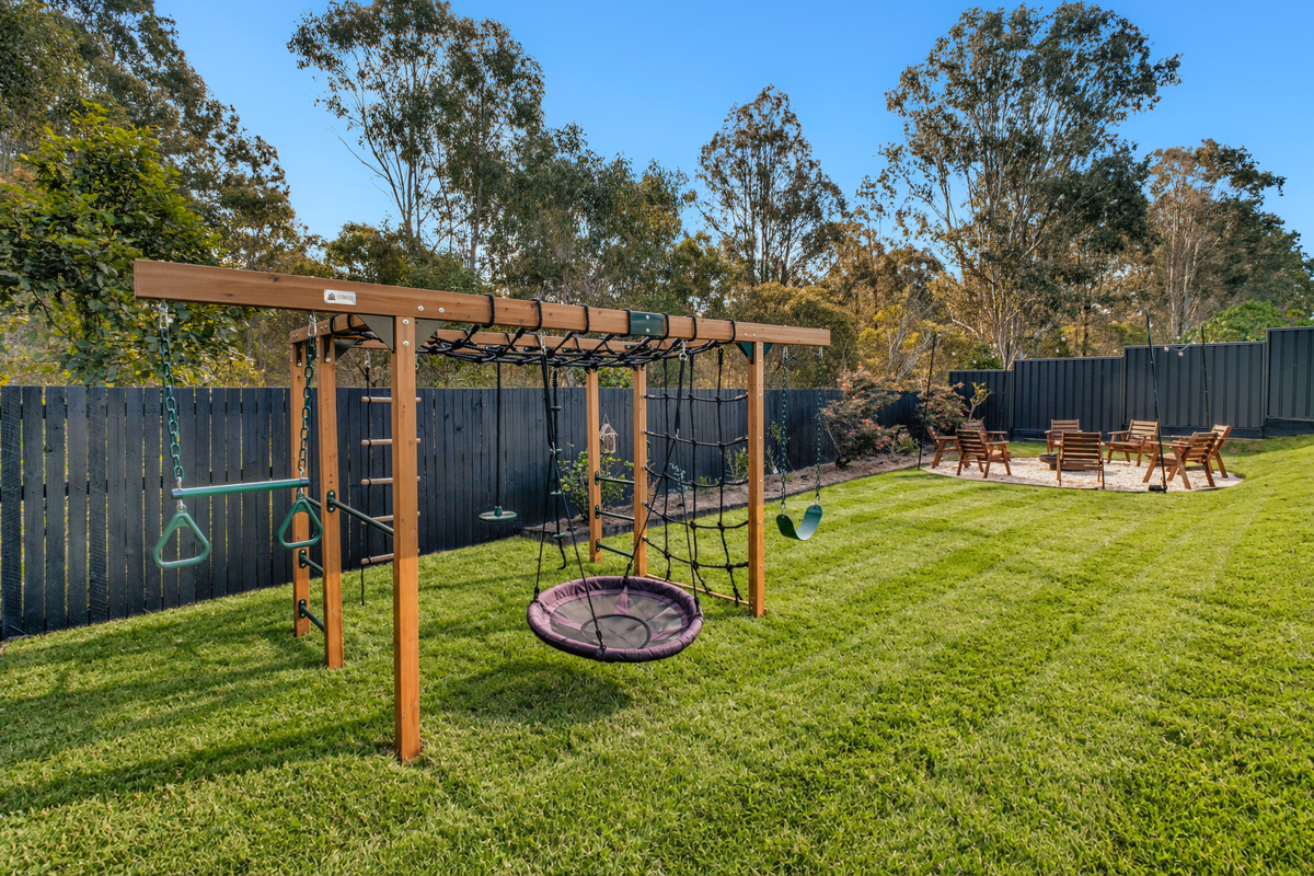 The backyard offers something for everyone, with a large lawn, fire pit seating, outdoor entertaining space and kids’ play area.