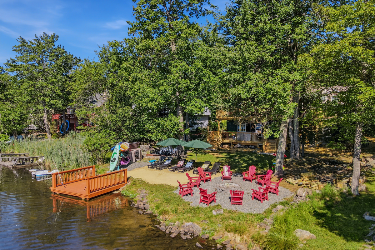 Aerial view of the private dock, shoreline seating, and kayak storage along Lake Carobeth