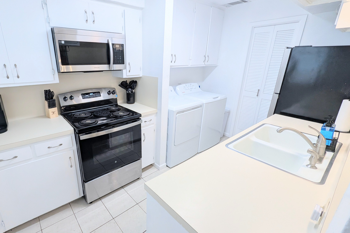 Kitchen is fully stocked and has an electric stove/oven and microwave. 