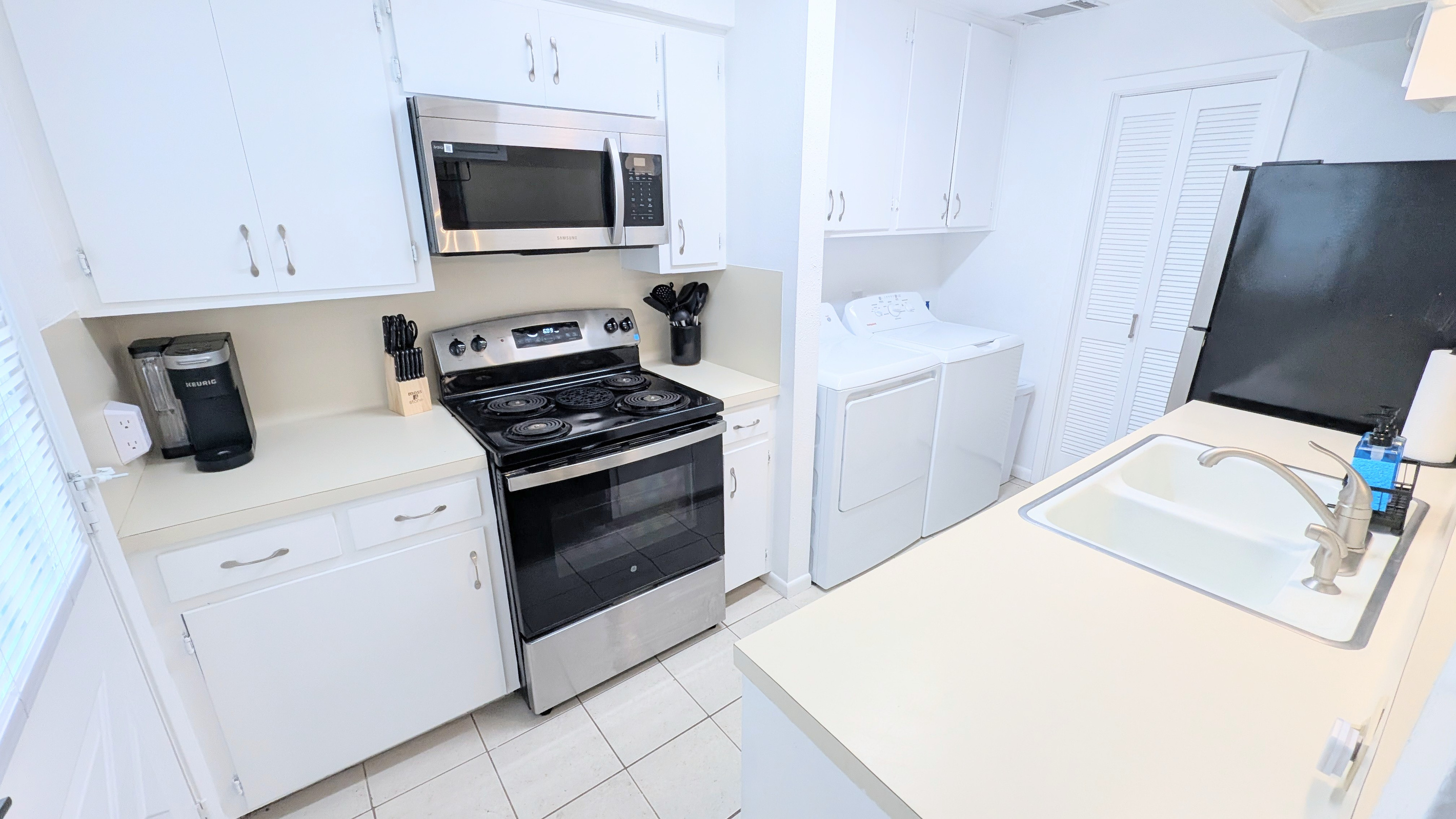 Kitchen is fully stocked and has an electric stove/oven and microwave. 