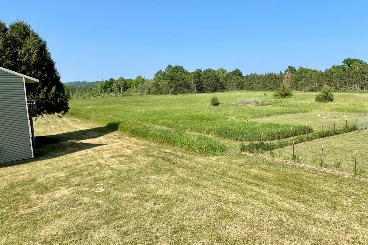 Breathe in the fresh air and take in stunning views of rolling meadows and forested tree lines. This peaceful, private setting offers the perfect escape—ideal for morning walks, birdwatching, or simply enjoying the serenity of nature.