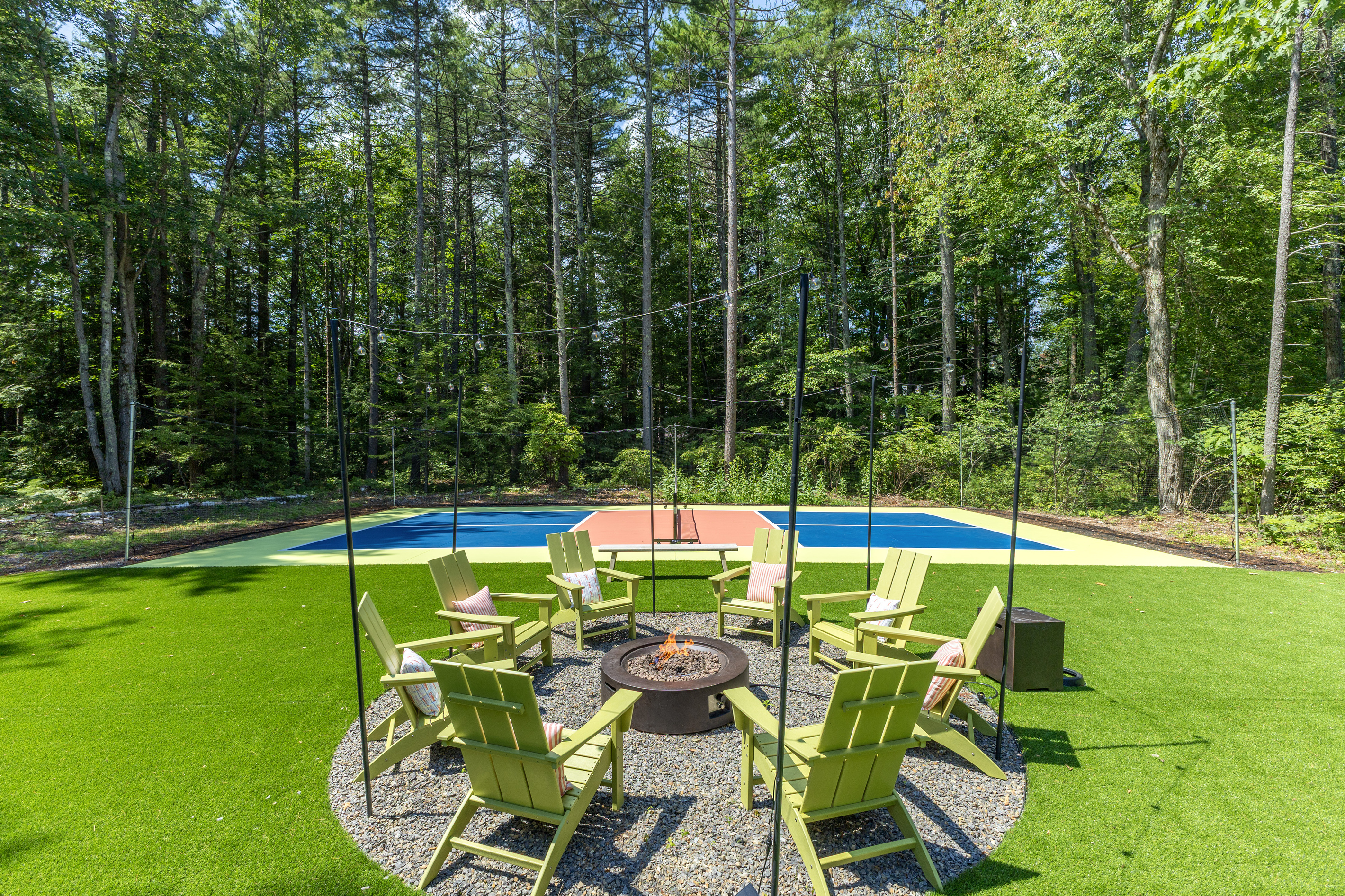 Our pickleball court and firepit, where energy meets warmth, and good times come together!