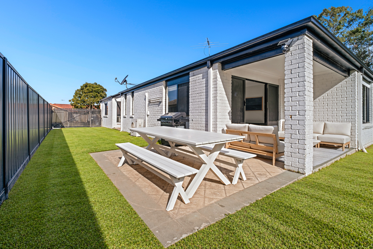 The perfect spot for outdoor living — enjoy sunny meals, relaxed conversations and fresh air in this inviting backyard retreat.