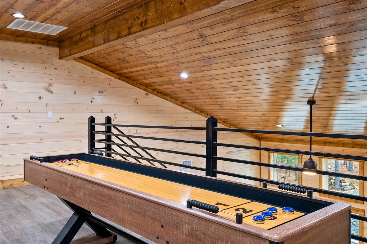 Just steps away, the shuffleboard table adds another classic game to the mix, giving everyone something to enjoy whether you're challenging friends or simply passing time between adventures.