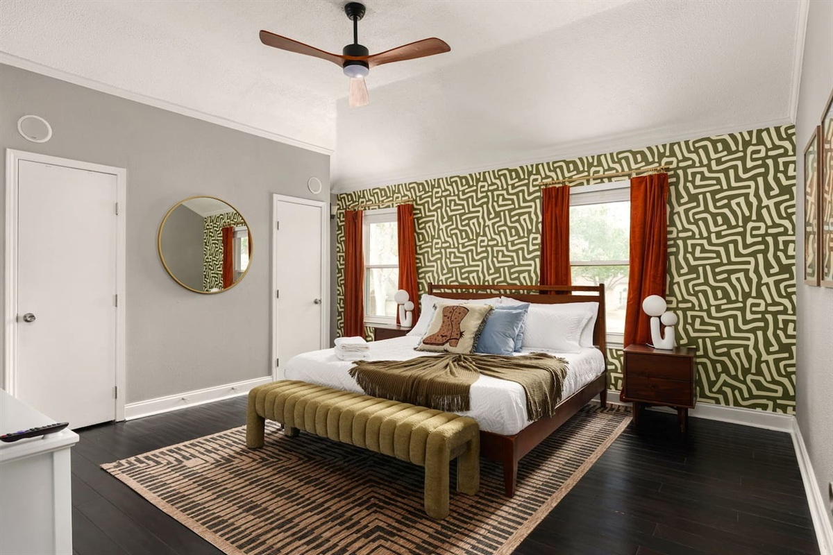 Bright and spacious primary bedroom featuring a king bed, modern décor, and cozy ambiance—perfect for restful nights