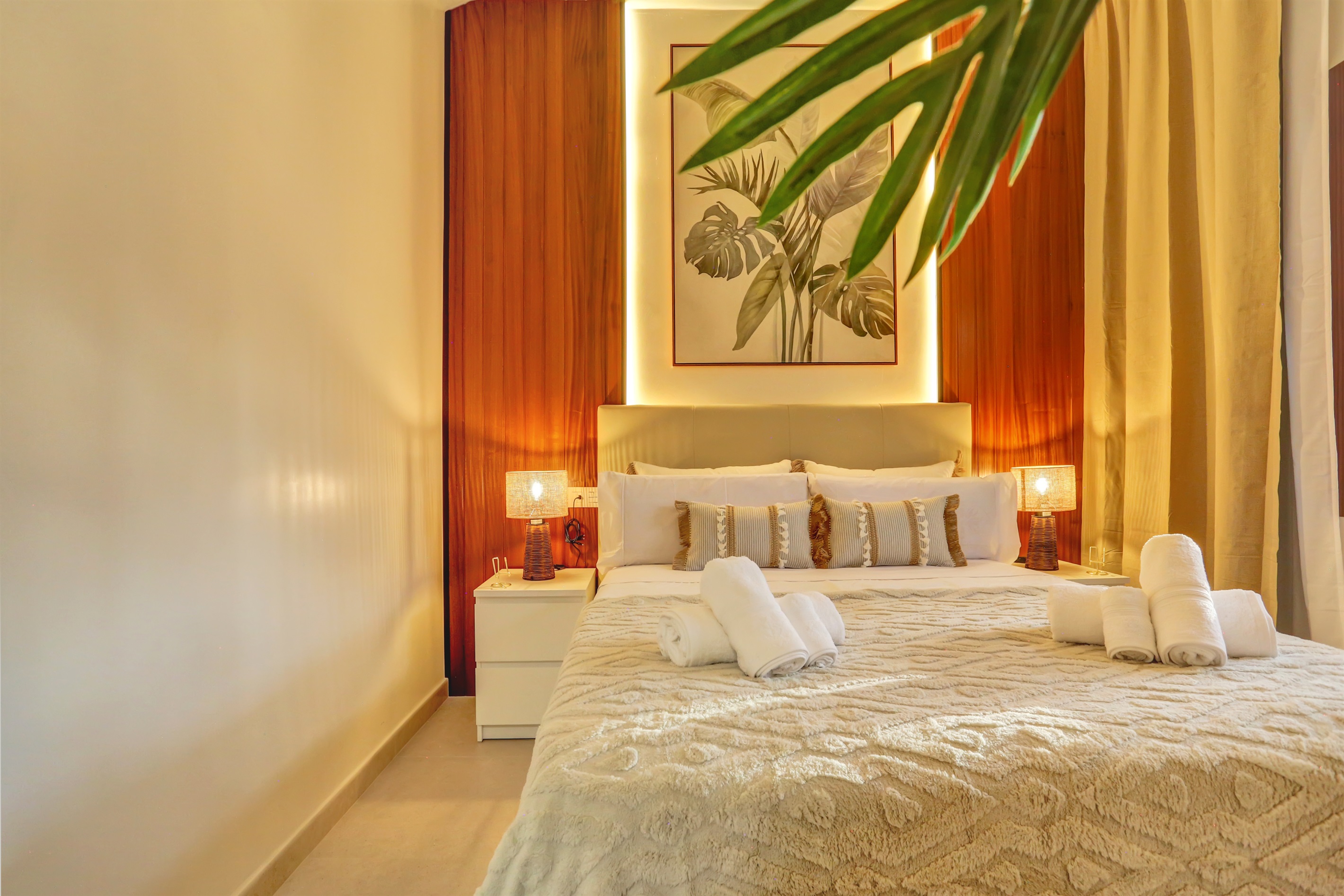 Cosy master bedroom with a double bed, warm lighting, and elegant décor that invites you to relax.