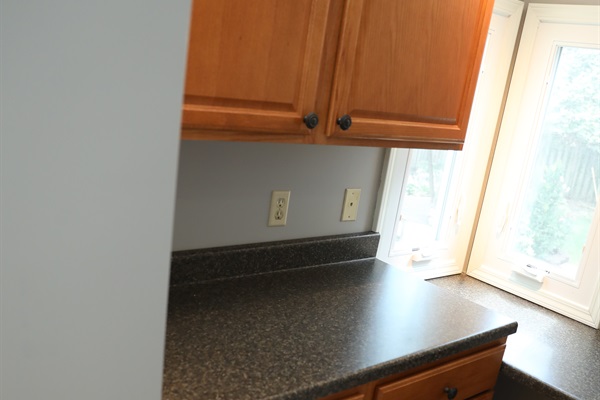 Laundry room showing cabinets and countertops