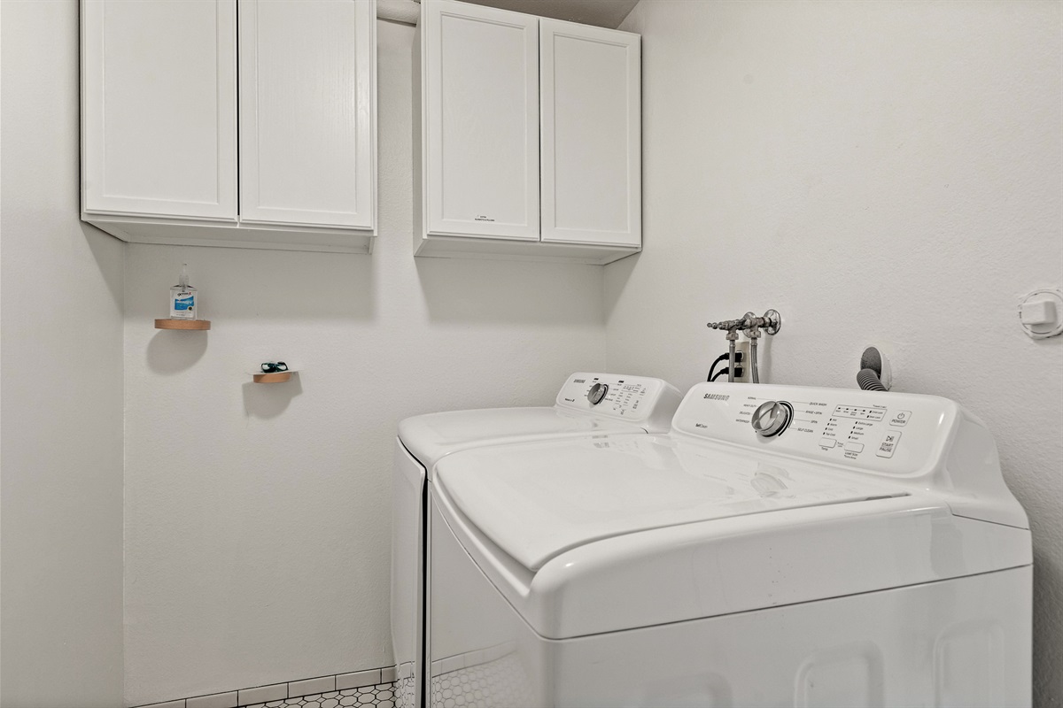 Convenient in-home laundry area with washer, dryer, and storage—everything you need for longer stays.