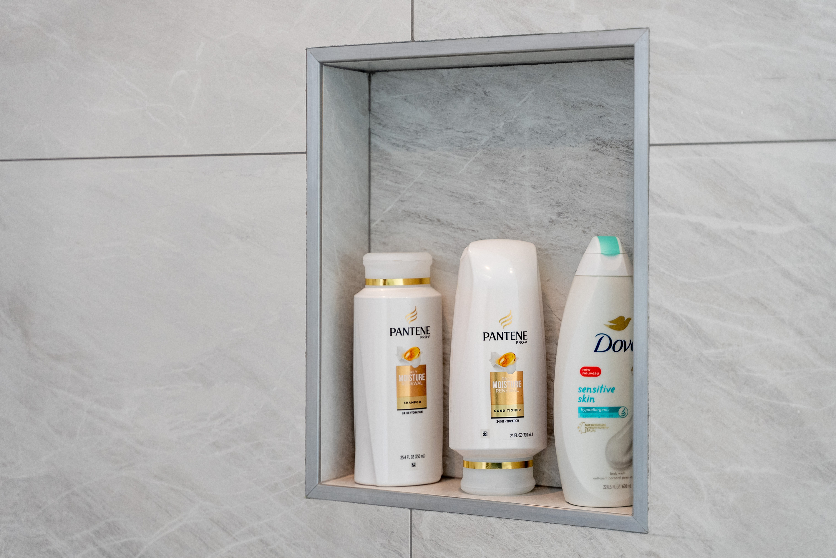 Built-in shower niche keeps essentials organized and within reach.