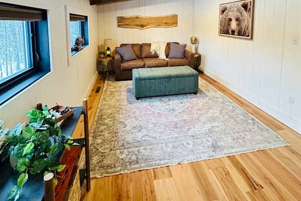 This cozy, open loft features a comfortable queen pullout sofa bed, perfect for two people. The loft overlooks the living room, offering a unique blend of privacy and openness, ideal for those who enjoy a spacious and airy living environment.