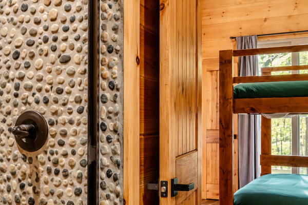 The bunk room gets its own stone-walled shower, so no one races down the hall.