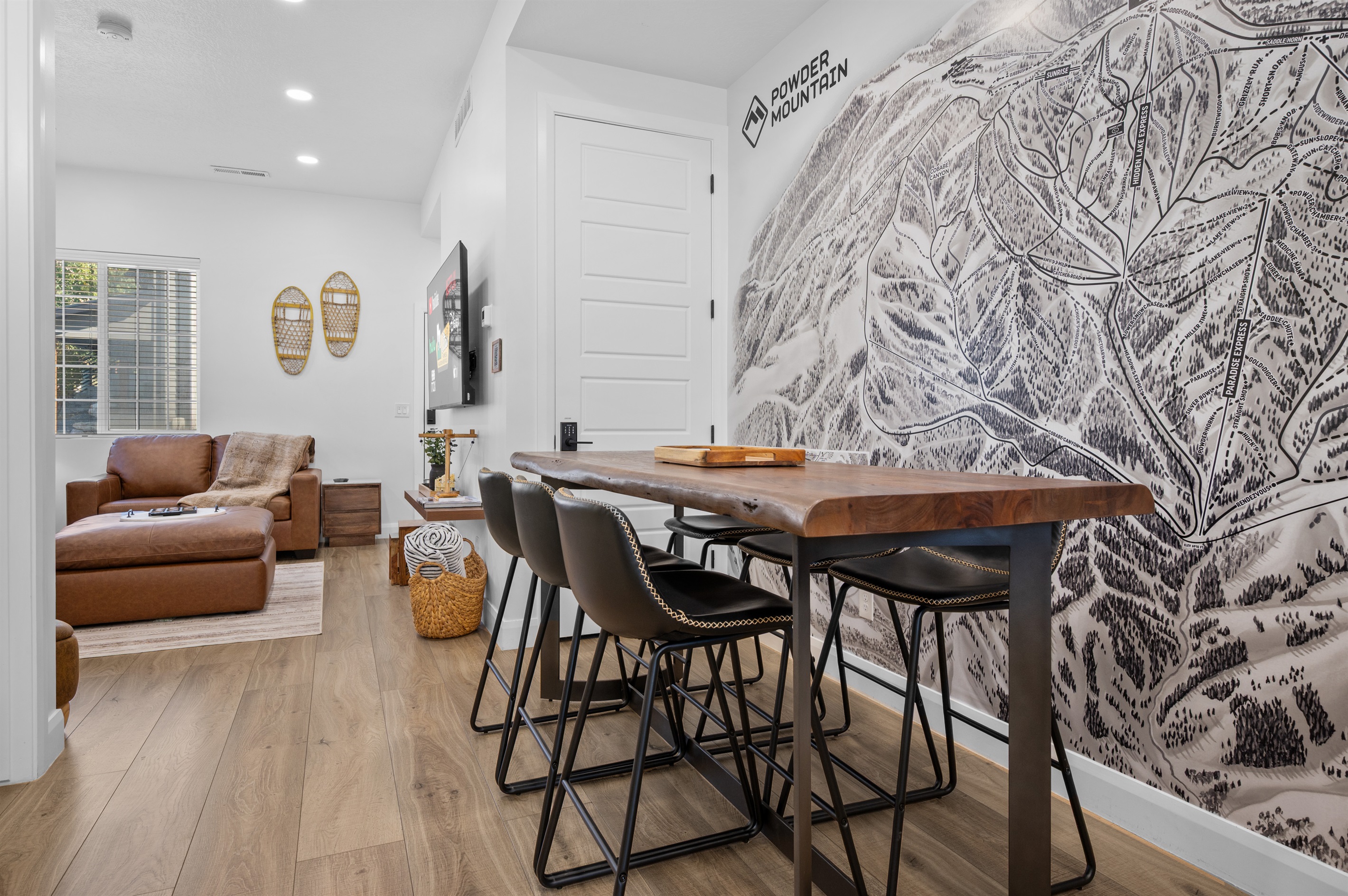 Dining area with seating for six beneath map of powder mountian..