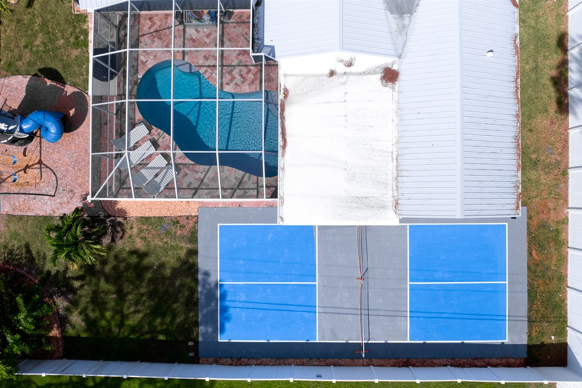 This aerial shot perfectly captures the charm of your retreat — from the refreshing pool and outdoor play area to the pickleball court, all set around a beautiful, private home. Relax, play, and make memories under the sun.