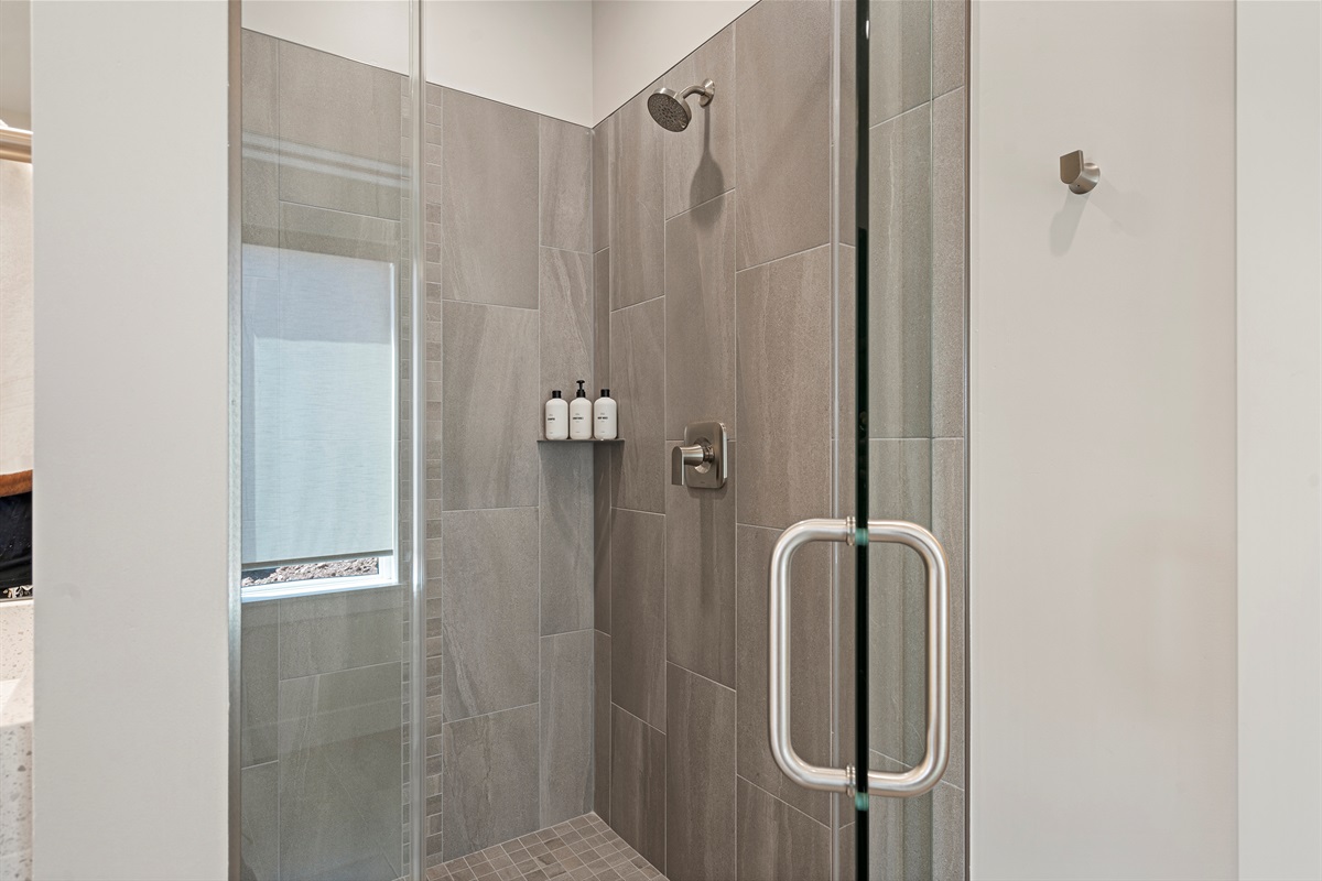 Walk-in shower with contemporary tile and glass enclosure.