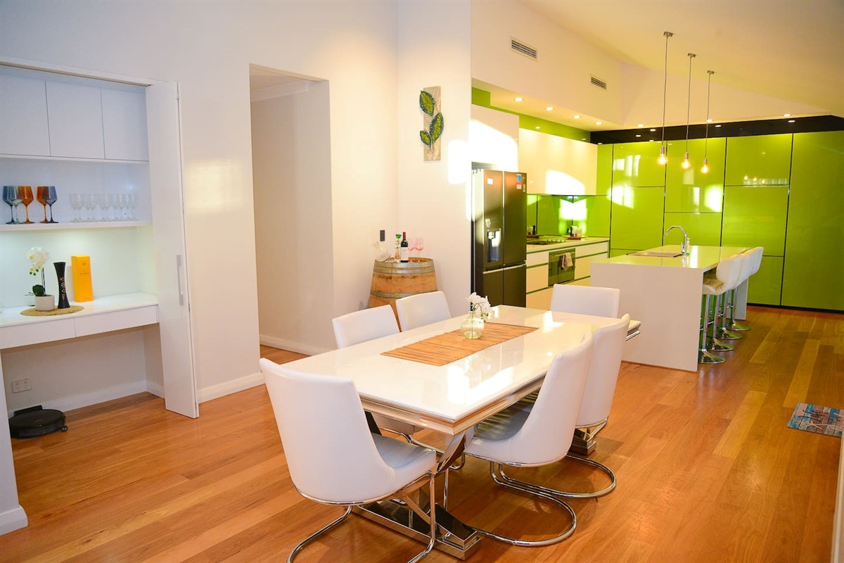 Indoor dining area beside the kitchen, with an eight-seat table and easy access to the main living spaces at Sant’s Beach Retreat.