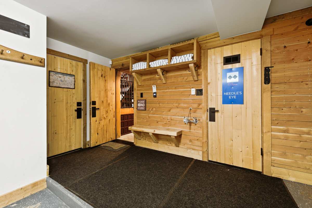 Space to leave the group's muddy or wet gear in the heated one-car garage. Garage entrance into the home is shown with door open to left of floating bench. 
