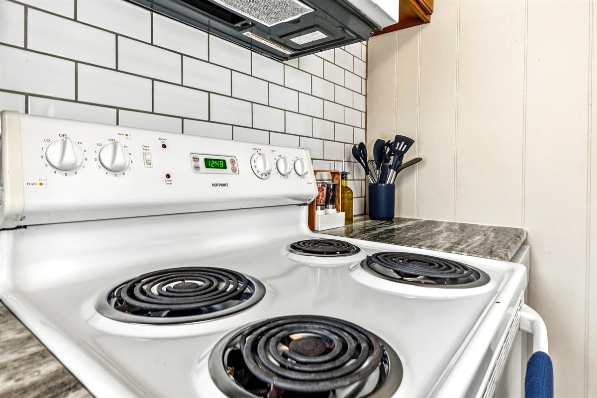The kitchen includes a full-size stove as well as plenty of pots and pans.