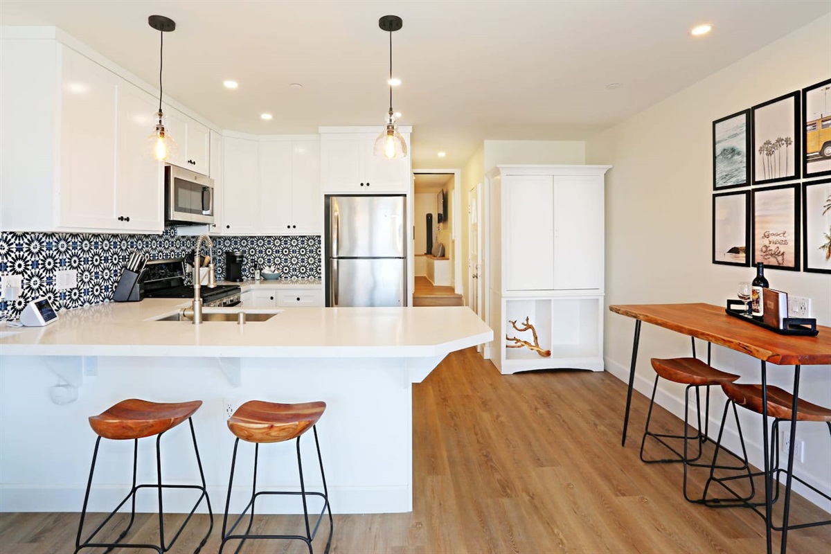 Fully remodeled in Aug 2021, the kitchen is fully equipped enough to prepare almost any meal. It also has quartz countertops, new appliances, and a breakfast bar.  See the stairs to the loft.  Only a 7ft ceiling in there but it's very cozy.