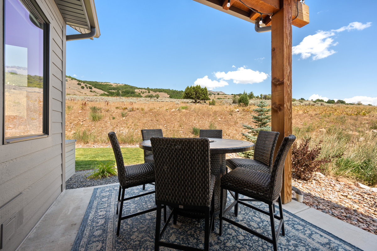 Share meals outdoors on the covered patio with peaceful hillside views and the fresh mountain air of Eden, Utah.