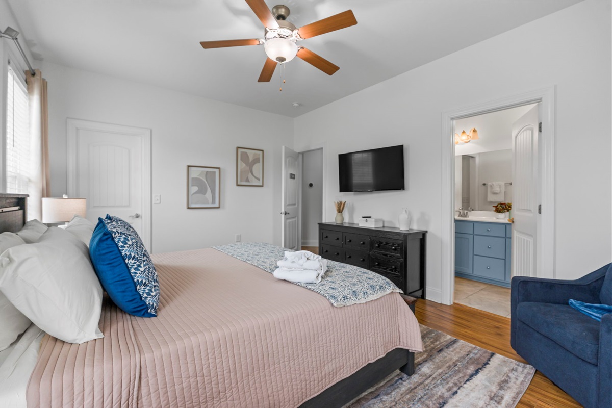 The Augusta Room - primary bedroom with king bed and ensuite bathroom