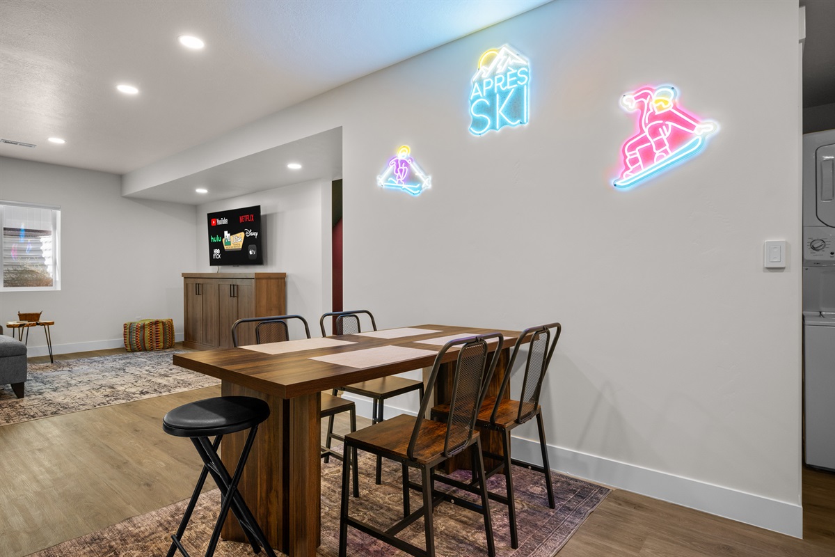 Cozy dining nook with neon ski-themed décor—perfect for casual meals or game nights.