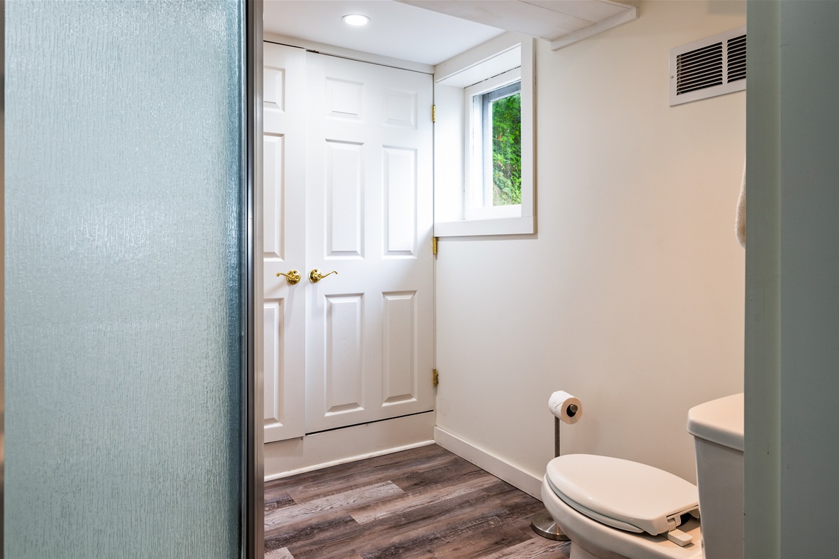 Clean and simple bathroom with a frosted glass shower and dual-door closet space—designed for comfort and privacy 🚿🚪✨