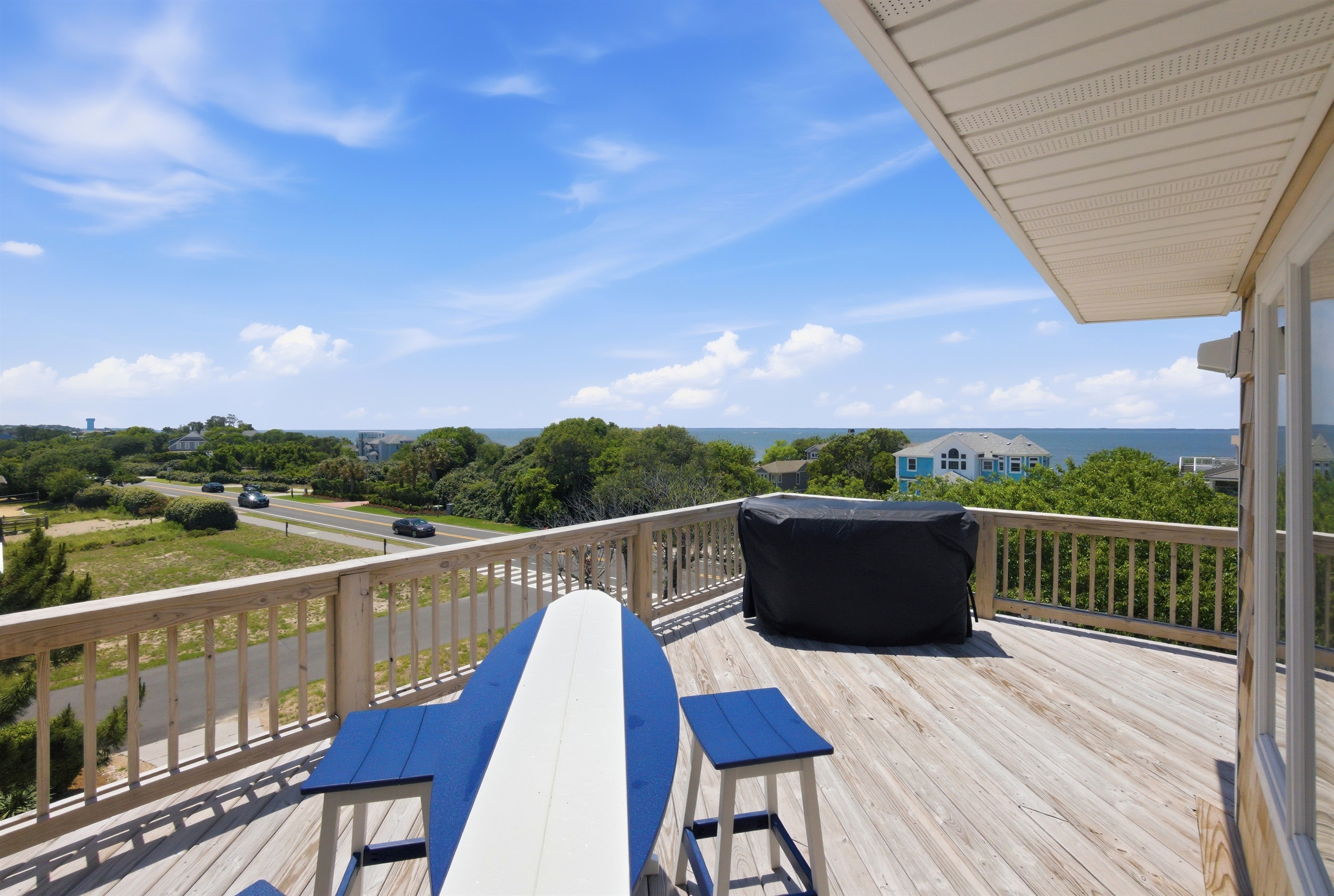Large sun deck with elevated views of the surrounding neighborhood and sound