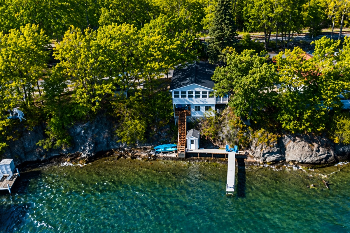Signature blue lake house perched right above the water—picture-perfect Finger Lakes gem