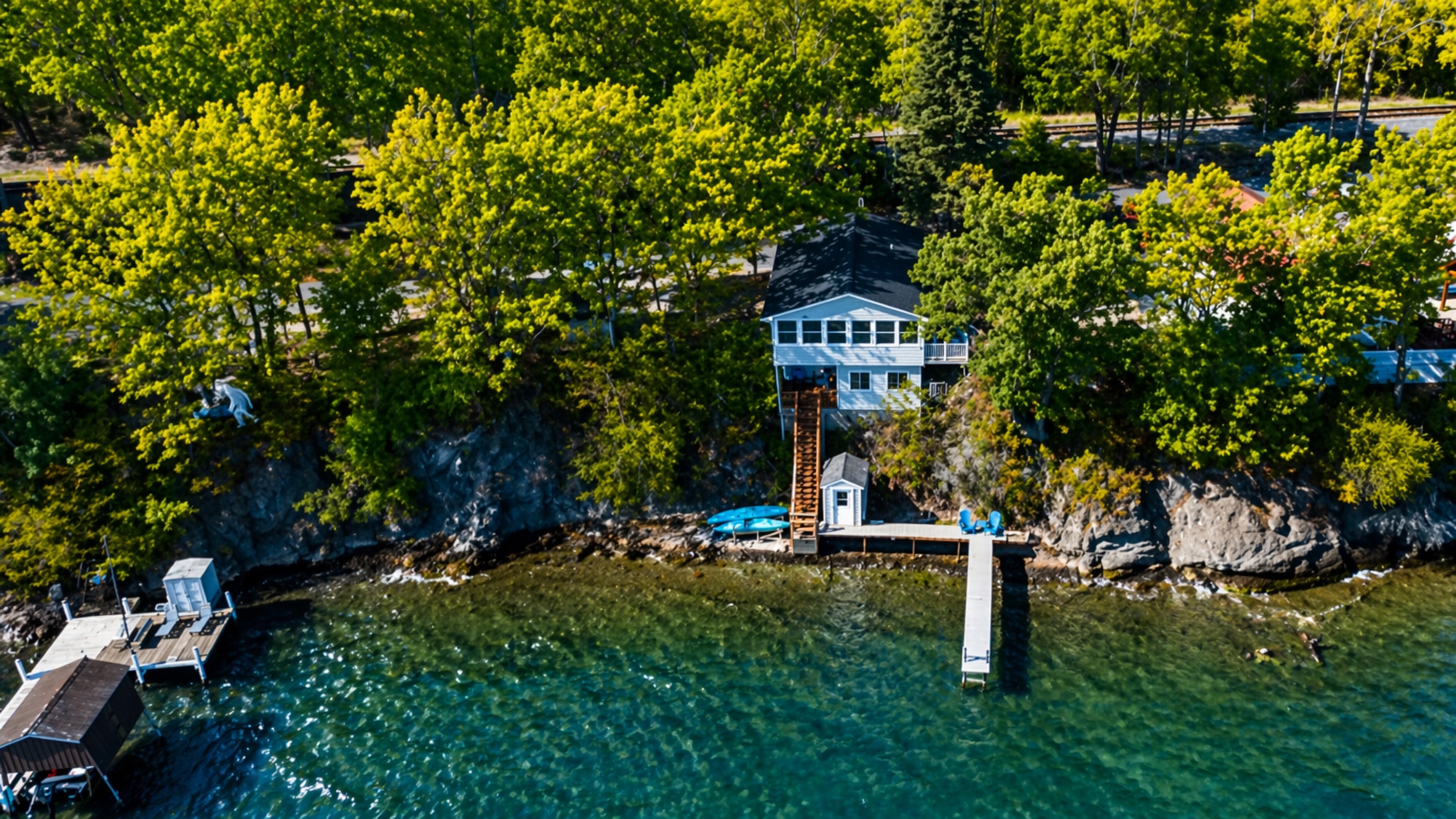 Signature blue lake house perched right above the water—picture-perfect Finger Lakes gem
