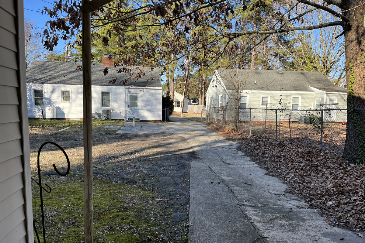 Williams Main — Shared driveway and rear parking area; marked spaces help keep the driveway clear.