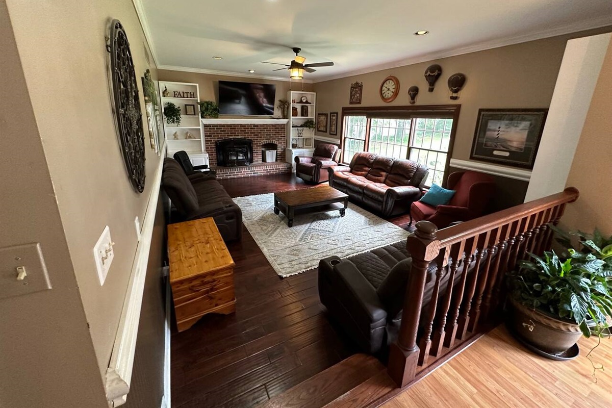 Relax on this large Family room  (16ft x 24ft) with 10 ft ceiling on the first floor. It has 3 full size sofas, and 2 single rocker recliners and 1 fixed chair. It has a large pellet stove in the fireplace for a winter backup to heat pump.