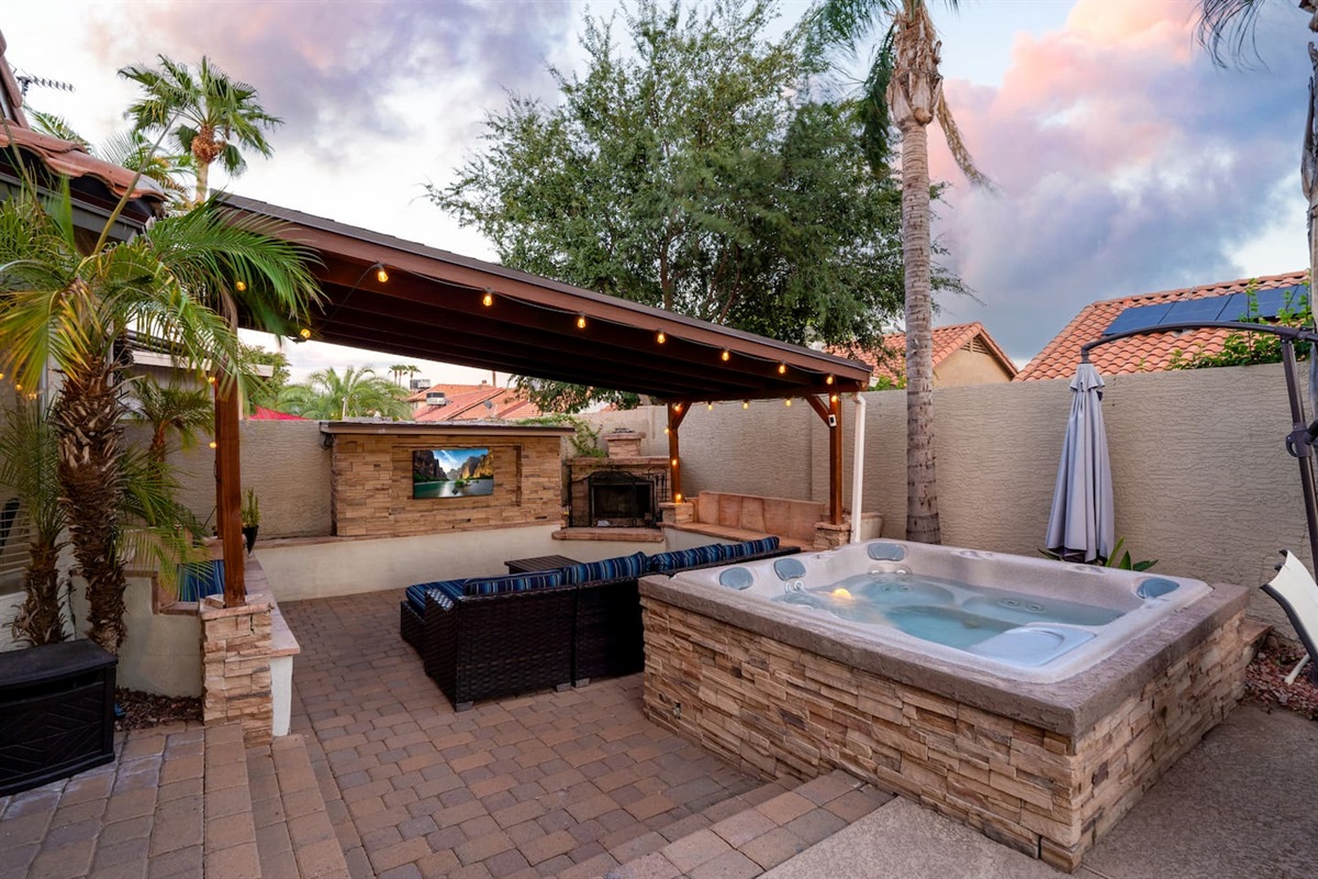 The patio is an outdoor paradise, with a relaxing hot tub, TV and plenty of seating.