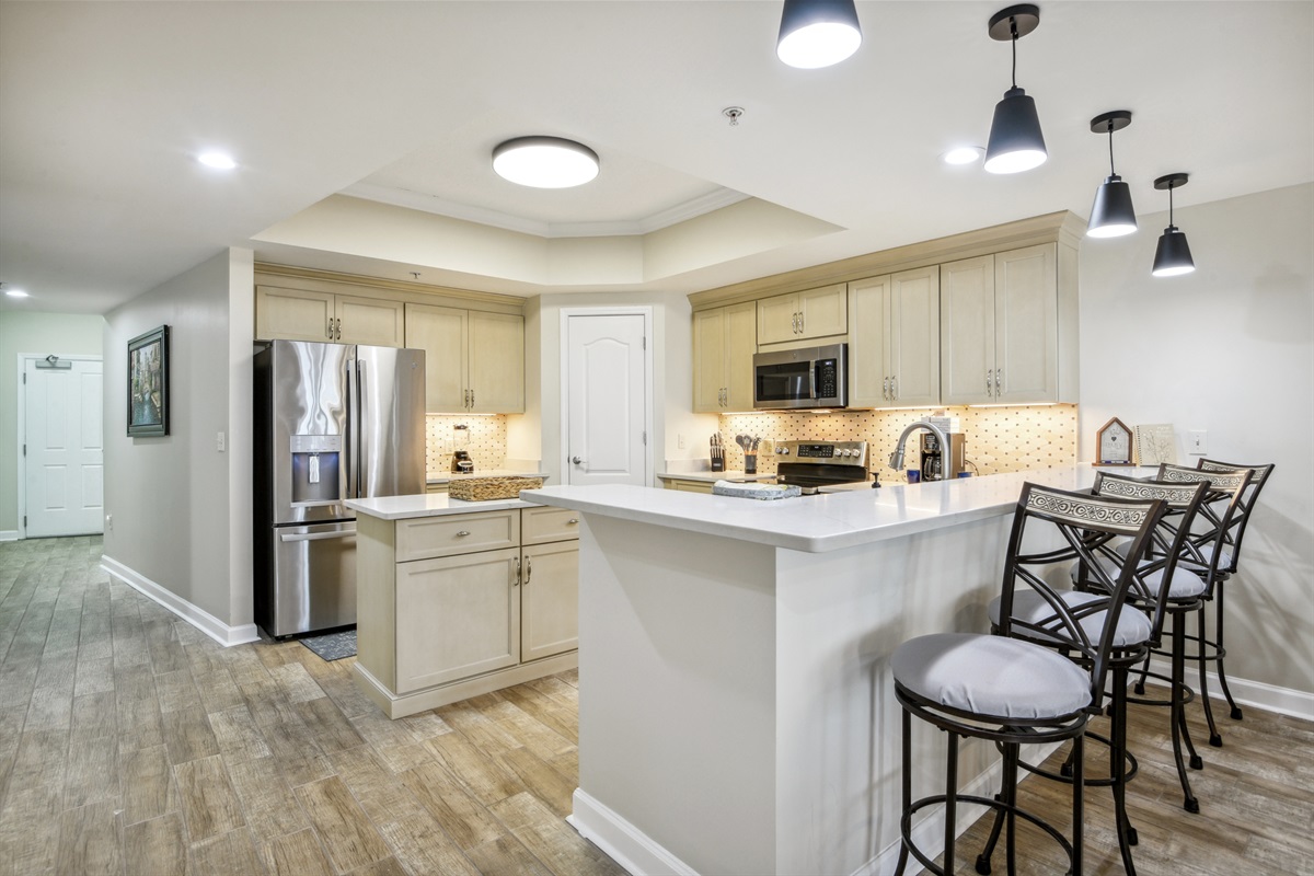 Kitchen, breakfast bar, front door to the left.