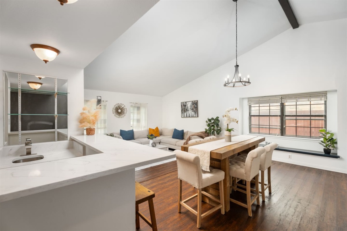 Bright open-concept living + dining area, and wet bar perfect for gathering with family and friends.