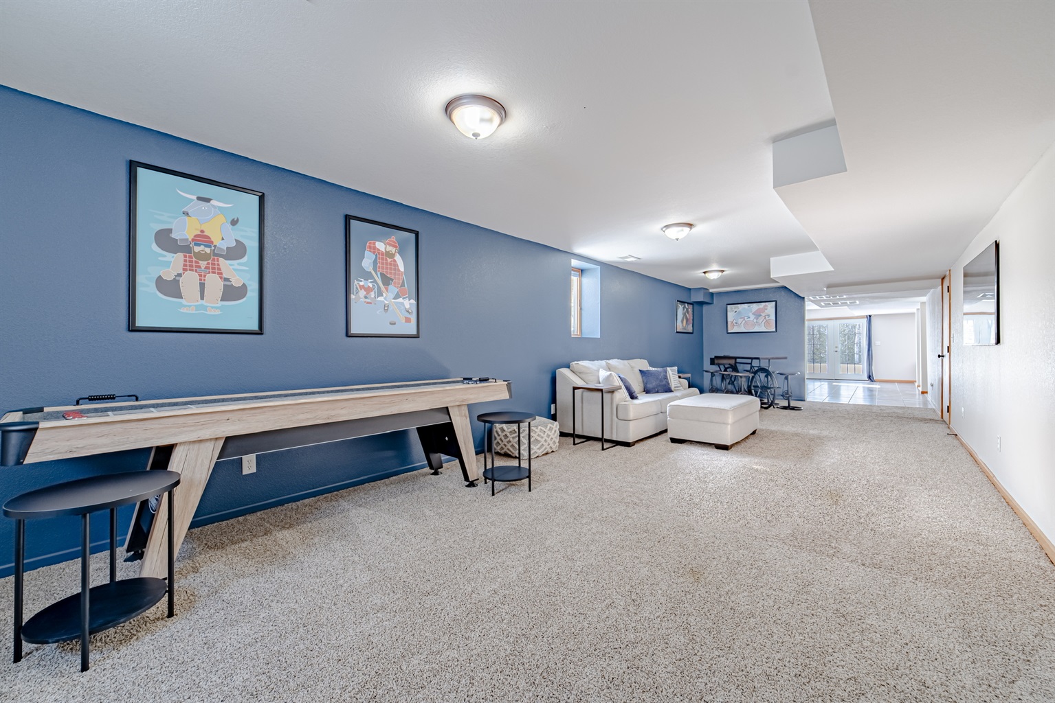 Entertainment space downstairs. Let the kids play for hours with a shuffleboard table, smart TV and room to set up some snacks.
