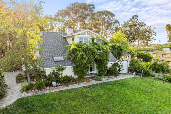 Your writing desk sits behind the large upstairs dormer, overlooking the lawn and pastures. Below, mature wisteria wraps your first floor glass french doors with ambiance and privacy. 