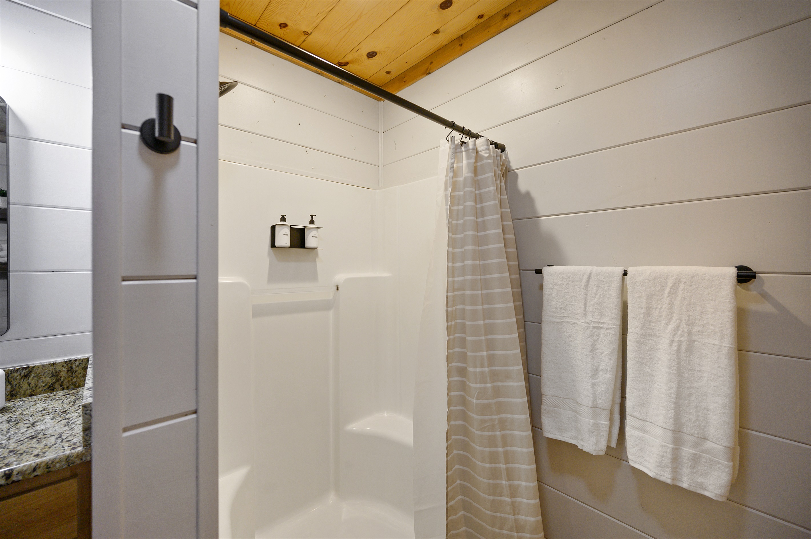 Indulge in relaxation with our sleek and modern bathroom featuring a refreshing shower.