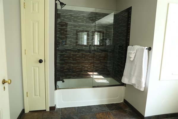 2nd Floor large full bathroom showing shower/tub, linen closet, and radiant heated flooring