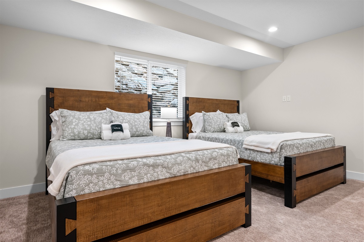 The lower level bedroom has two queen beds.
